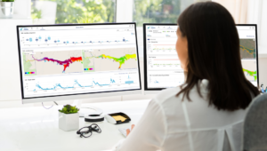 woman in front of two screens, looking at data of eoapp AQUA